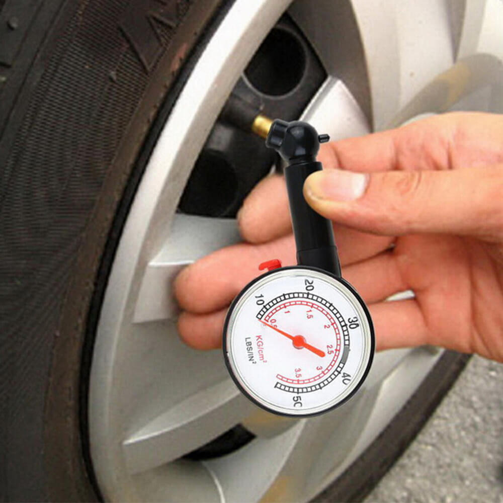 manually checking car tire pressure