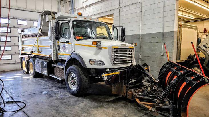 Dump truck with plow in for commercial auto services