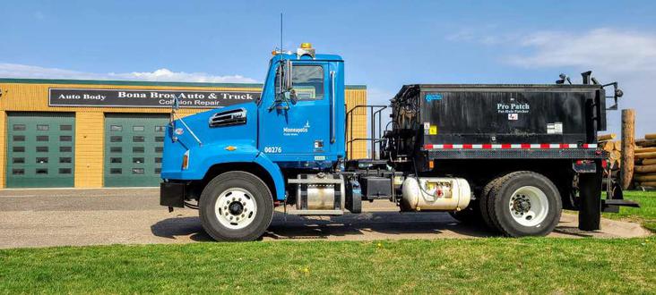 Dump truck outside Bona Brows Auto & Truck