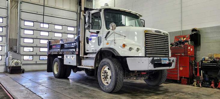 Dump truck in commercial auto shop
