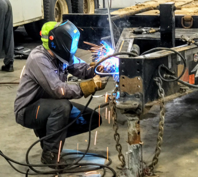 Mechanic repairing on utility trailer