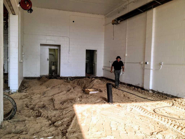 Brian preparing the ground for the new concerete floor in the shop