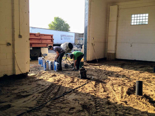 Brian J. and David Bona pouring concrete for the new overhead door