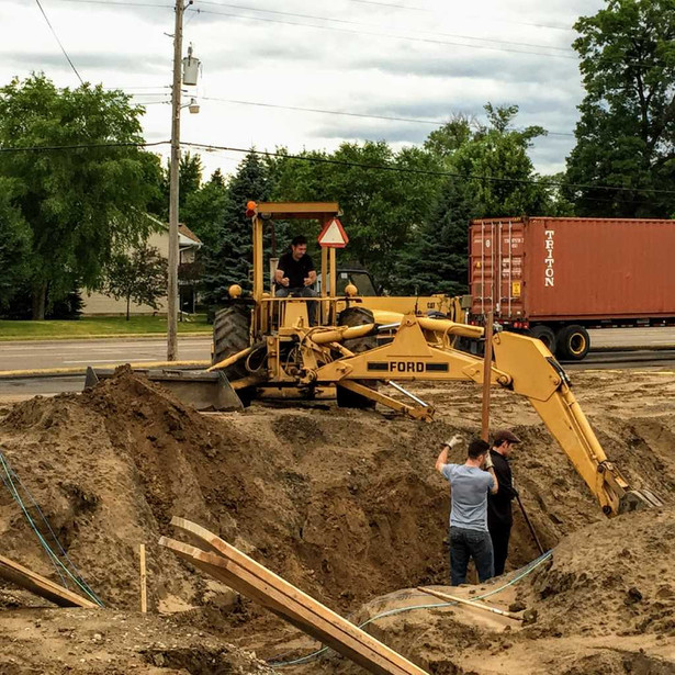 Brian, David, and Stephen Bona digging the footings - this is the same Ford tractor used to expand Paul's Pro in the 1990's