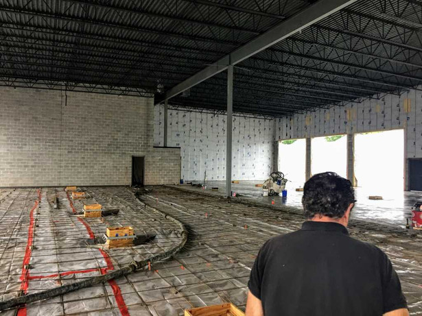 Brian setting the floor drains before the new concrete floor is poured