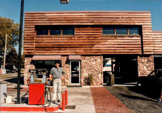 Brian standing next to new gas pumps and brick paved entryway